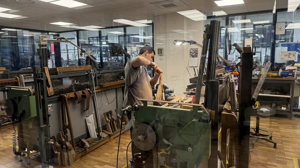 When you first walk through the doors of Gun Service, on your way to the front desk, you pass through a hall of windows giving a clear view of the Beretta gunsmiths, handworking custom projects.